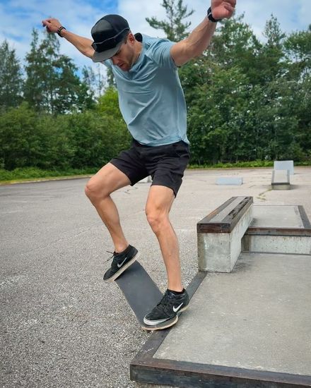 A skateboarder mid-trick on a concrete ledge
